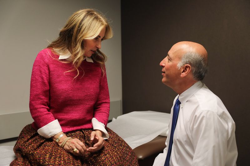 Dr. Richard Berger, right, chats with his patient, Debbie Korb of New York, on Jan. 7. Berger replaced Korb's knee in 2016. (Abel Uribe / Chicago Tribune)